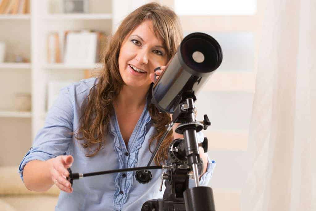 telescope mounts explained, woman moving controls of mount